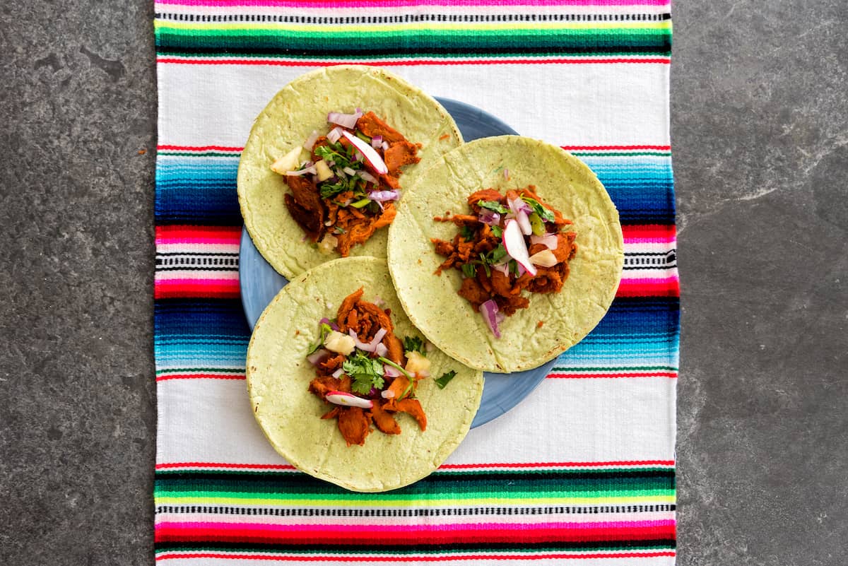 Fresh Mexican tacos on table with chili sauce